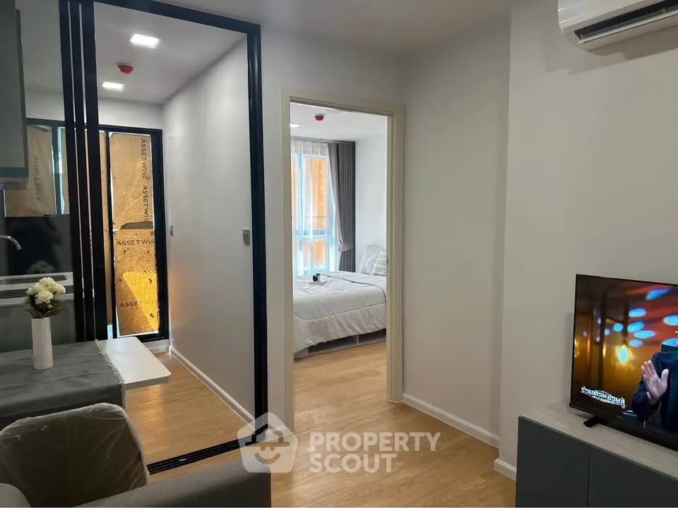 Modern apartment interior with open living space and cozy bedroom view.