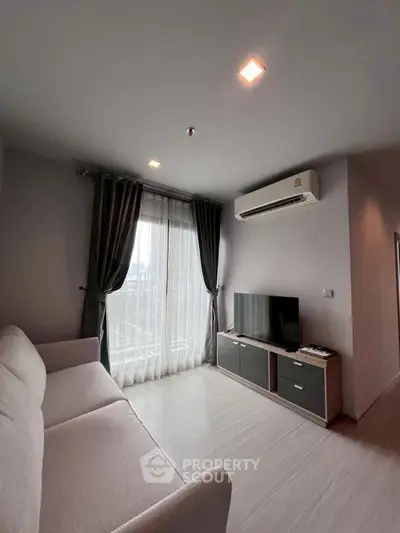 Modern living room with sleek design, featuring a cozy sofa, flat-screen TV, and large window with city view.