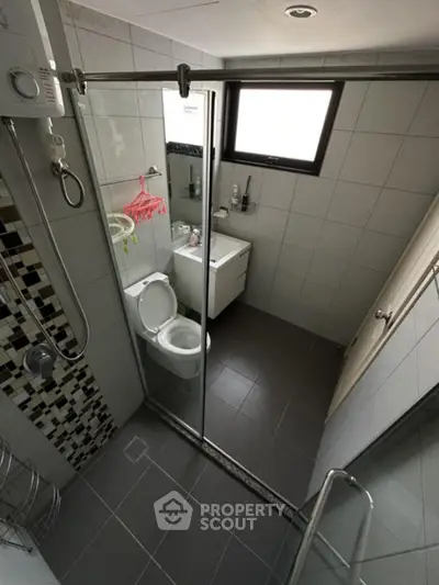 Modern bathroom with sleek glass shower and stylish tile accents.
