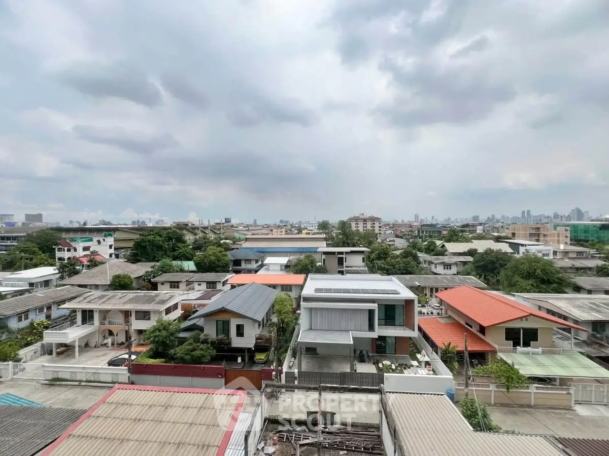Stunning aerial view of suburban neighborhood with diverse rooftops and lush greenery, perfect for real estate investment.
