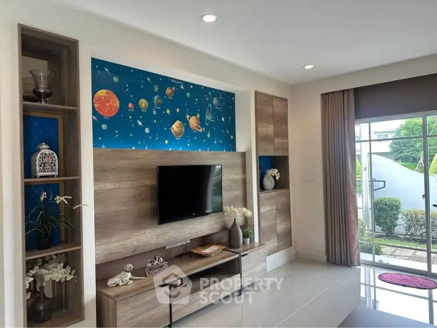 Modern living room with stylish TV unit and space-themed decor