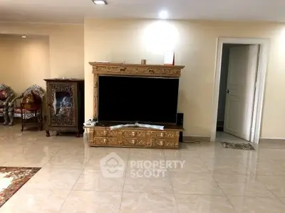 Spacious living room with elegant wooden TV cabinet and tiled flooring