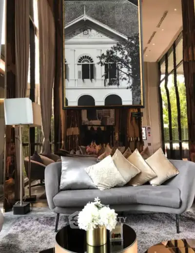 Luxurious living room with elegant decor and large windows offering natural light.