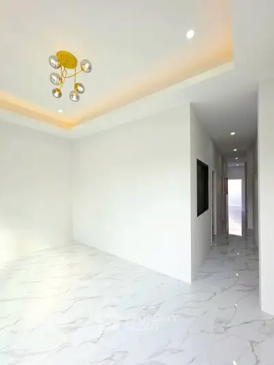 Spacious modern interior with elegant lighting and marble flooring, perfect for stylish living.