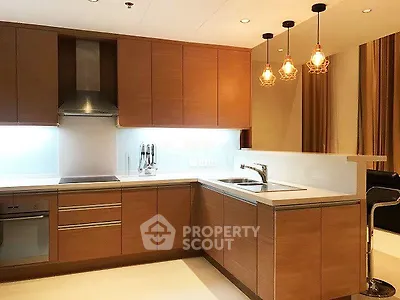 Modern kitchen with sleek wooden cabinets and stylish lighting