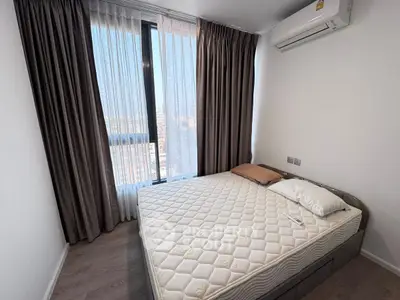 Modern bedroom with large window and air conditioning in a high-rise apartment.