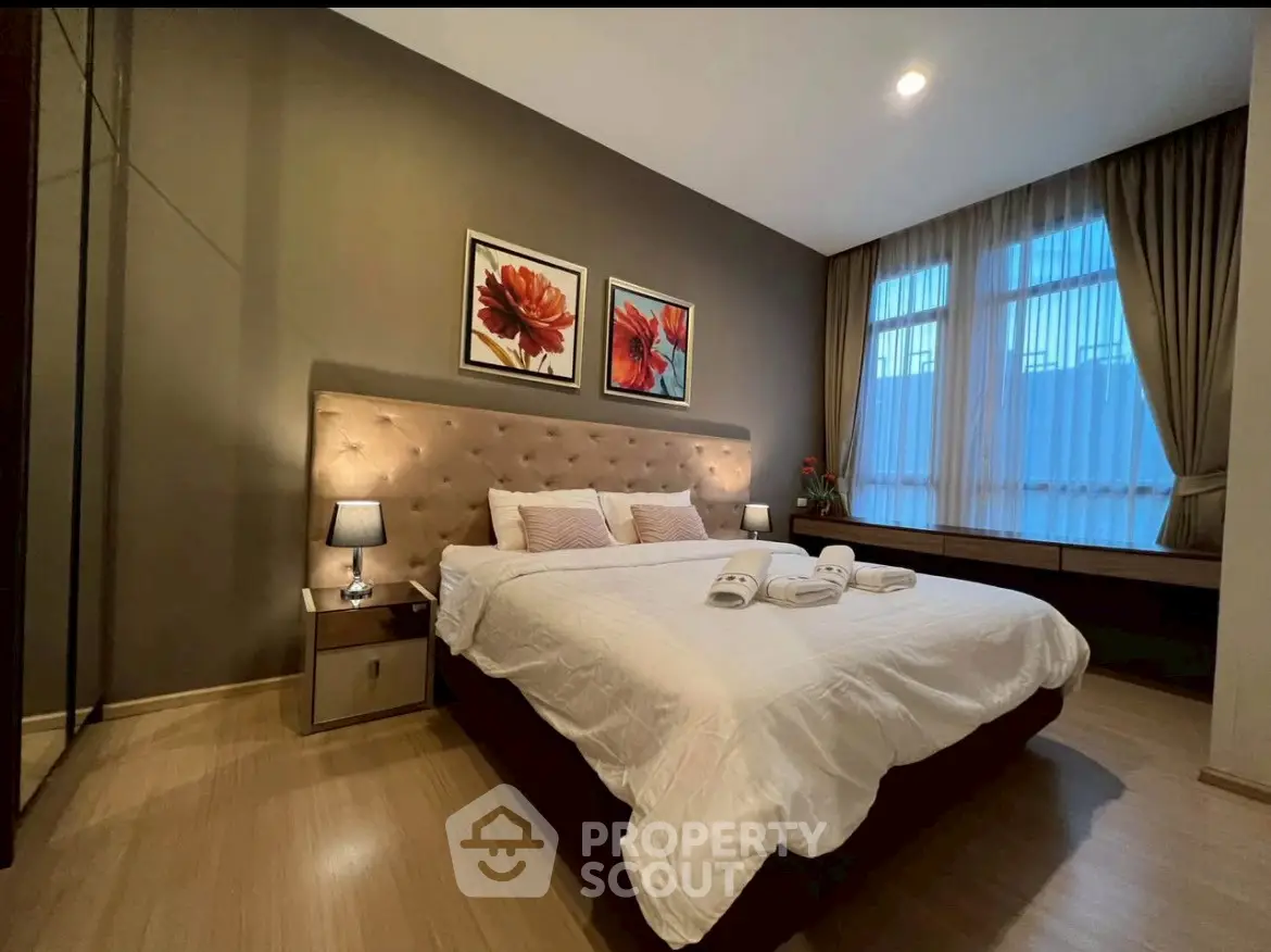 Luxurious bedroom with elegant decor and large window for natural light