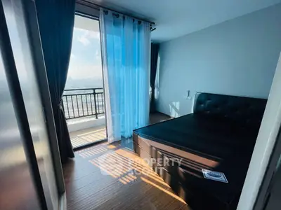 Modern bedroom with balcony view and stylish decor in a high-rise apartment.