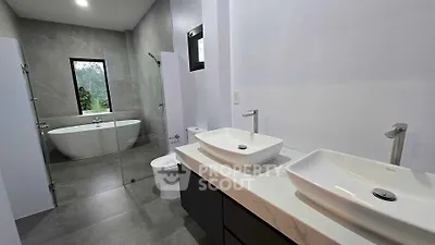 Luxurious modern bathroom with dual sinks and freestanding bathtub