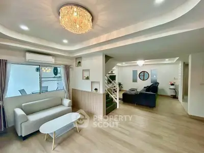 Spacious modern living room with elegant chandelier and stylish furniture