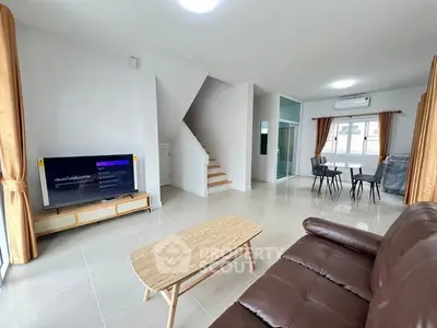 Spacious modern living room with sleek furniture and open dining area, perfect for entertaining.