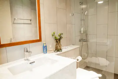 Modern bathroom with sleek fixtures and glass shower enclosure