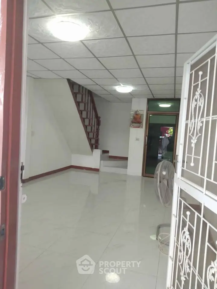Spacious interior with staircase and tiled flooring, ideal for modern living.