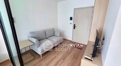 Cozy living room with modern sofa and TV setup, perfect for relaxation.