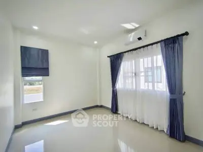 Bright empty room with large windows and elegant curtains, perfect for customization.