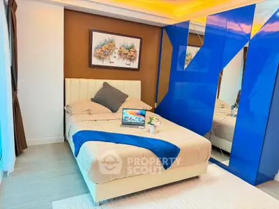 Modern bedroom with stylish blue mirrored wardrobe and cozy bed setup