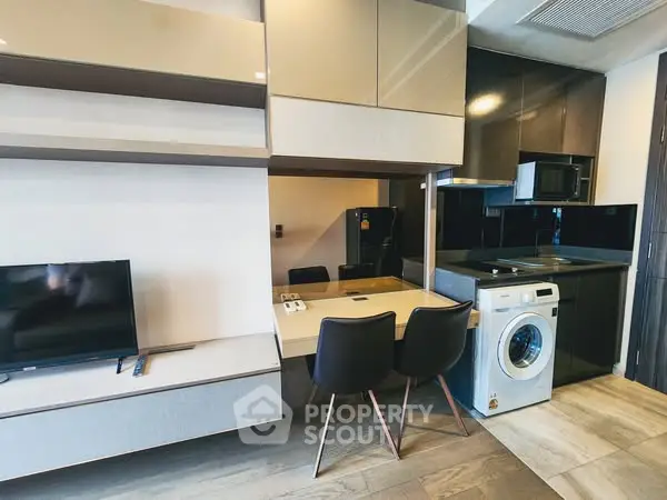 Modern apartment interior with sleek kitchen and laundry area