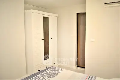 Cozy bedroom with white wardrobe and modern decor