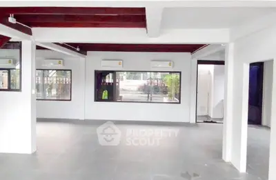 Spacious open-plan interior with modern design and large windows for natural light.