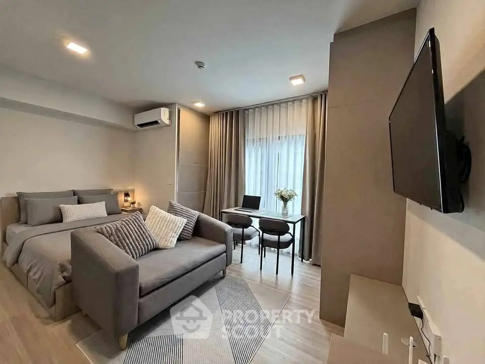 Modern studio apartment with cozy living area and stylish decor