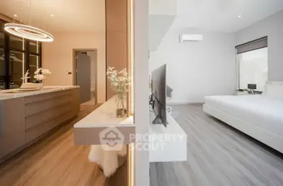 Modern open-plan bedroom and living area with sleek design and elegant lighting.