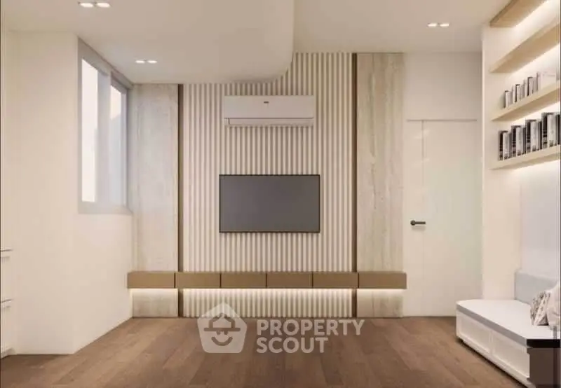 Modern living room with sleek design, wooden flooring, and built-in TV unit.