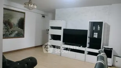 Spacious living room with modern white furniture and stylish decor
