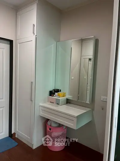 Modern bedroom with built-in wardrobe and stylish vanity area.