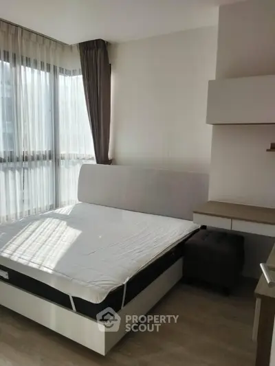 Modern bedroom with large windows and minimalist furniture, perfect for natural light lovers.