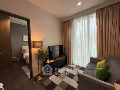 Modern living room with cozy sofa, TV, and large window in stylish apartment