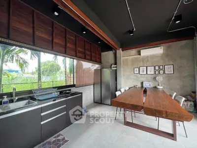 Modern industrial kitchen with sleek design and spacious dining area