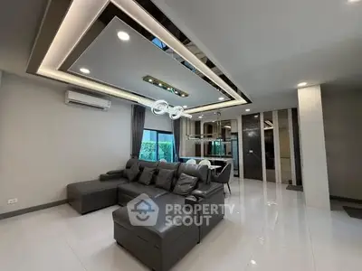 Modern living room with stylish ceiling design and comfortable seating in a contemporary home.