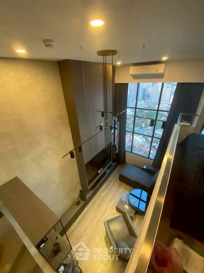 Modern loft-style living room with high ceiling and city view