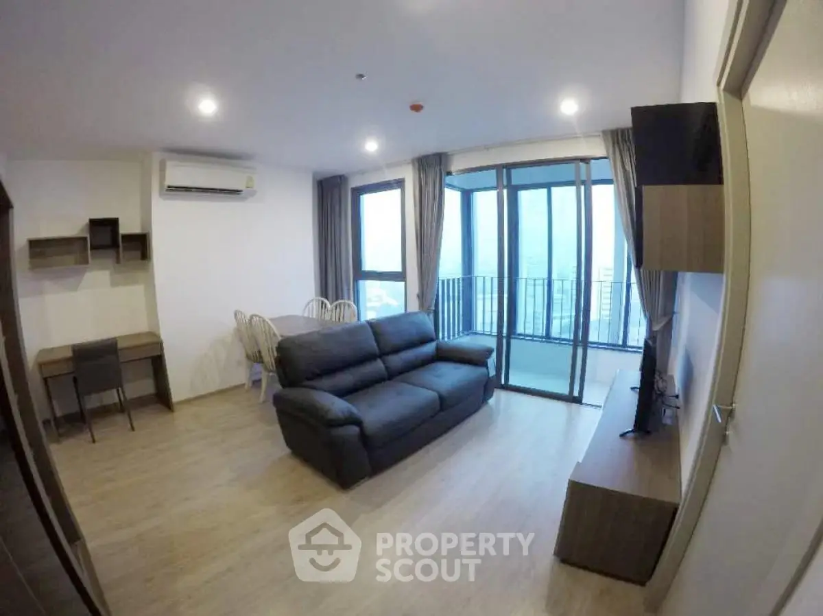 Modern living room with balcony and city view in high-rise apartment