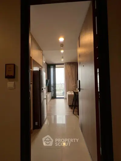 Modern apartment entrance with view of cozy living area and balcony