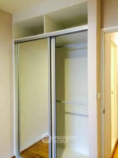 Spacious built-in closet with sliding doors in modern apartment
