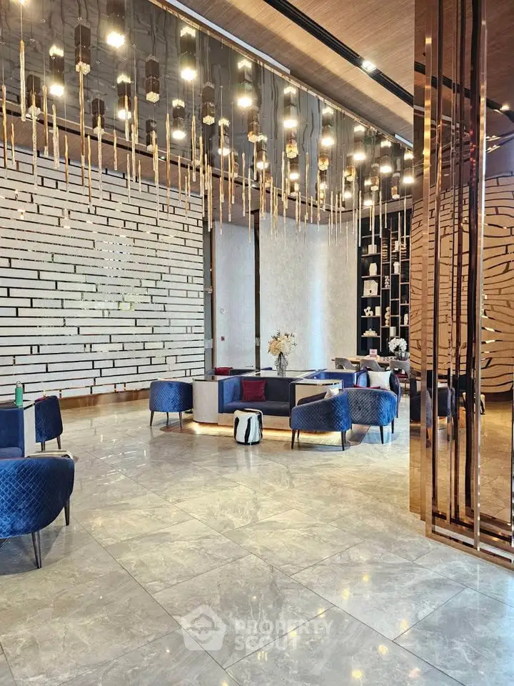 Luxurious modern lobby with elegant lighting and stylish seating in a high-end building.
