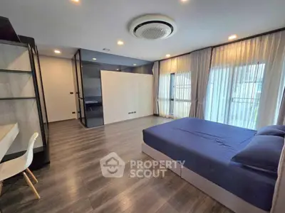 Spacious modern bedroom with large windows and elegant decor