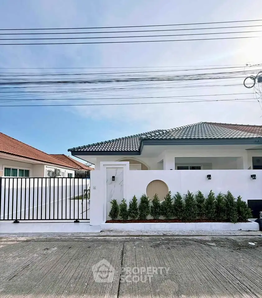 Charming single-story house with modern design and lush greenery in a serene neighborhood.