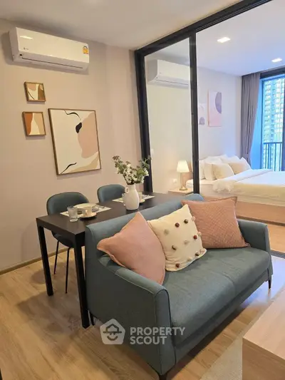 Chic modern living room with cozy dining area and stylish decor in a high-rise apartment.