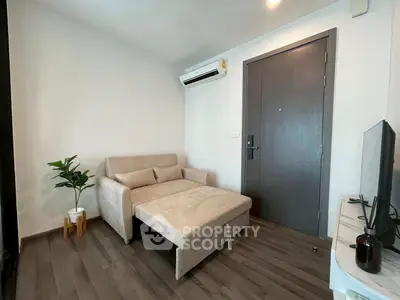 Cozy living room with sofa bed and modern decor in a stylish apartment.