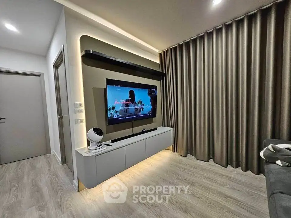 Modern living room with sleek TV setup and elegant curtains