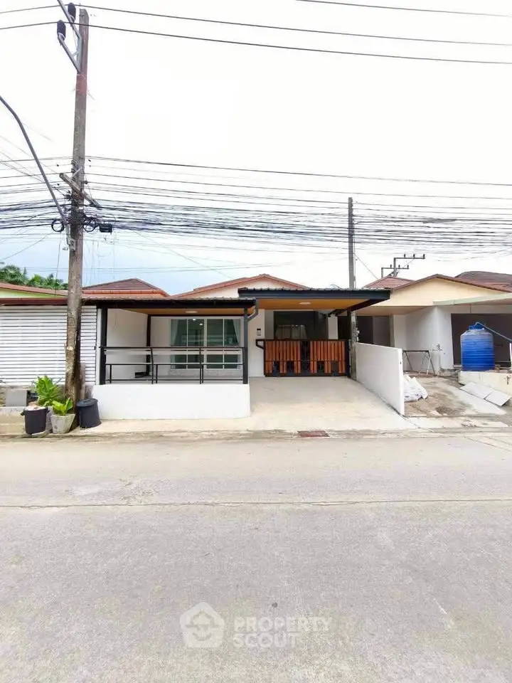 Charming single-story house with a covered porch and modern exterior design, perfect for family living.
