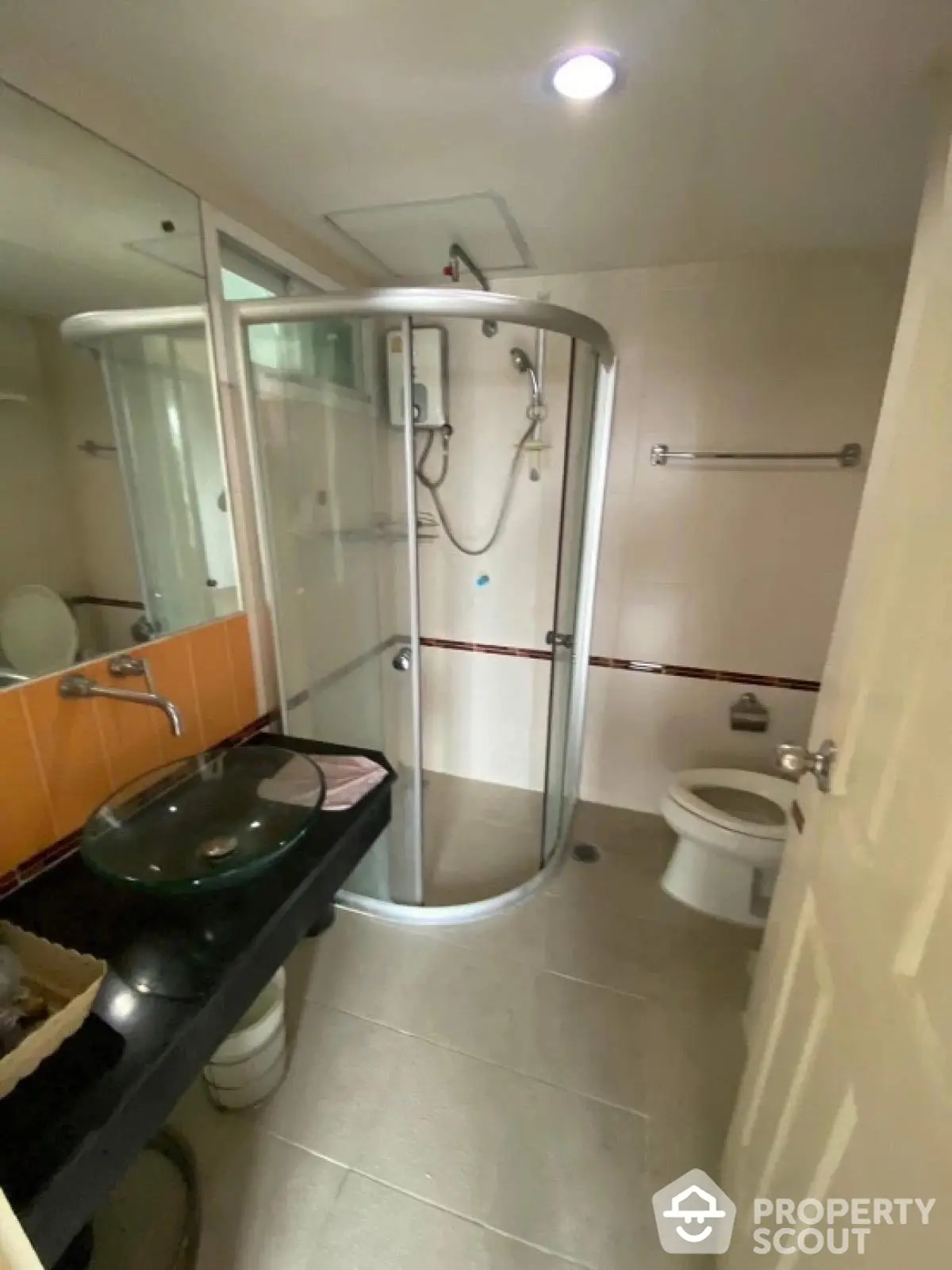 Modern bathroom with glass shower enclosure and sleek fixtures