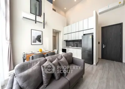 Modern open-plan living room with sleek kitchen and stylish decor
