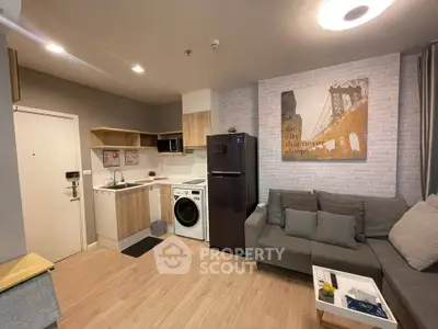 Modern apartment interior with cozy living room and compact kitchen featuring washing machine and fridge.