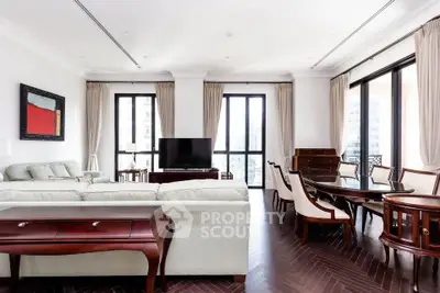 Luxurious living room with elegant furniture and large windows offering city views.
