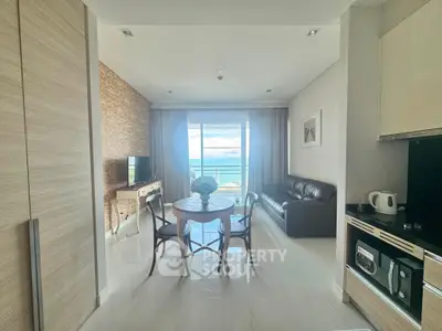 Modern living room with ocean view, stylish furniture, and open layout for a luxurious lifestyle.