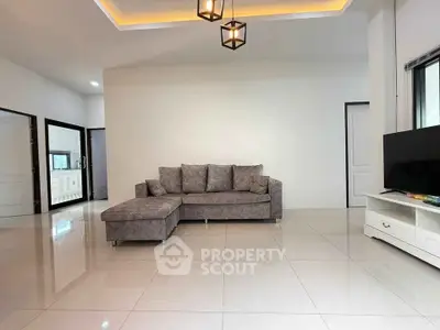 Spacious modern living room with sleek gray sofa and minimalist decor