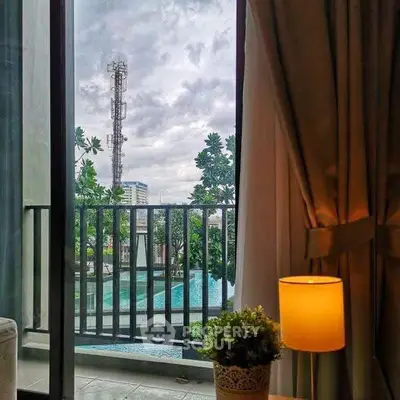 Chic apartment with balcony view overlooking pool and cityscape, perfect for urban living.